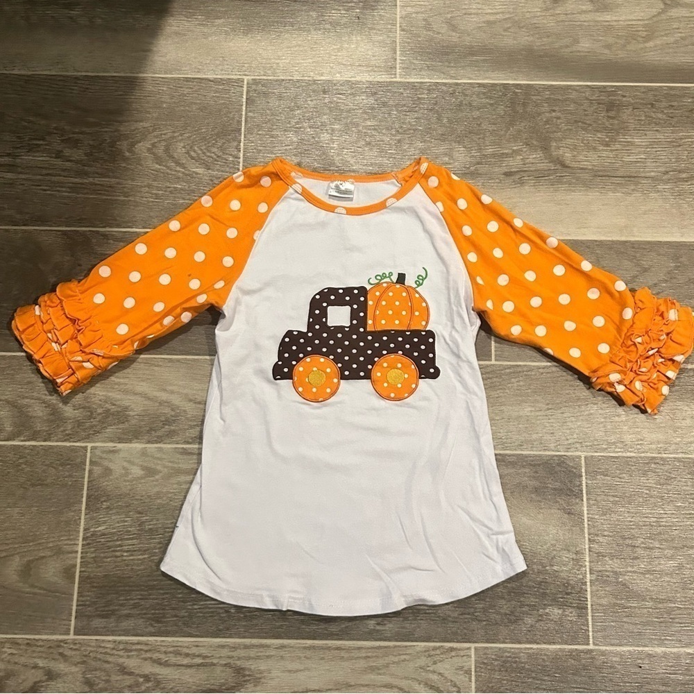 .**3/$15**Girl's 7/8 Triple Ruffle Sleeve Raglan Tee Pumpkins Fall